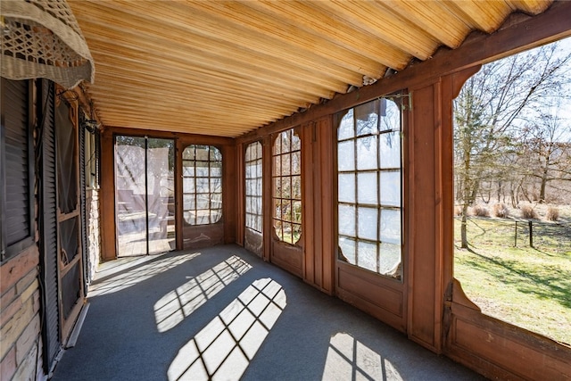 unfurnished sunroom featuring wooden ceiling