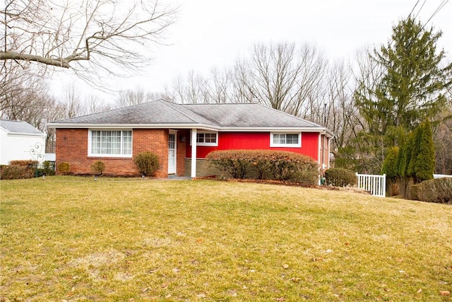 ranch-style home with brick siding and a front yard