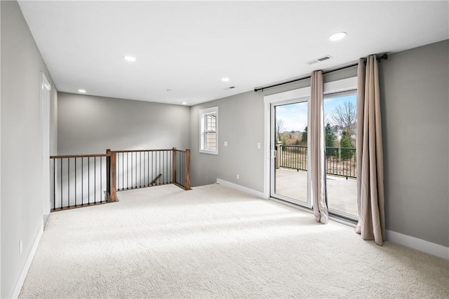 carpeted empty room with recessed lighting, visible vents, and baseboards