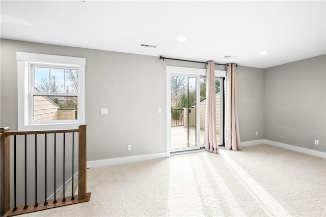 spare room with carpet, visible vents, baseboards, and recessed lighting