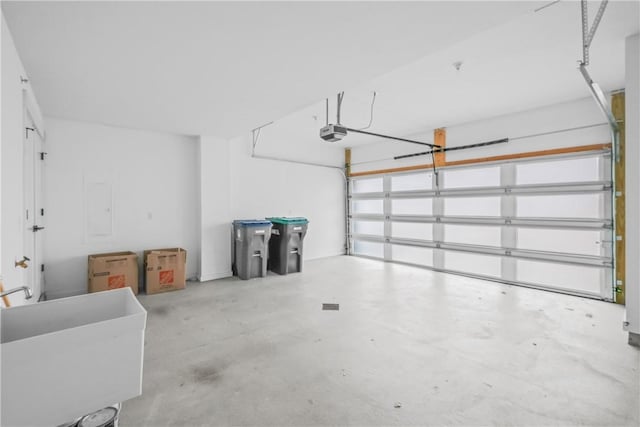 garage with a sink and a garage door opener