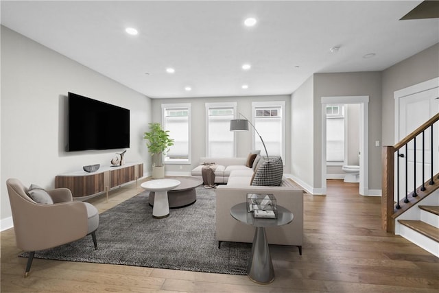 living room with recessed lighting, stairway, baseboards, and wood finished floors