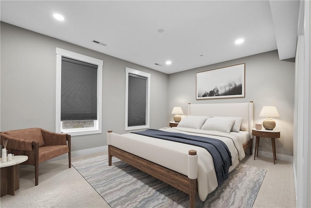 bedroom with light colored carpet, recessed lighting, visible vents, and baseboards