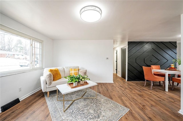 living room with baseboards and wood finished floors