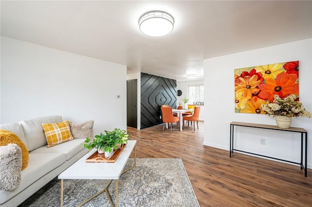 living area with baseboards and wood finished floors