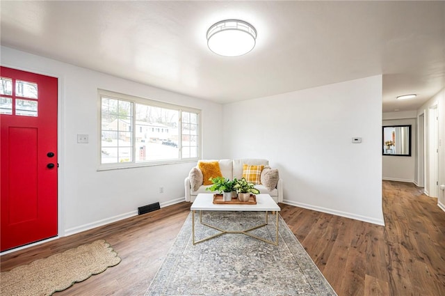 entryway featuring wood finished floors, visible vents, and baseboards