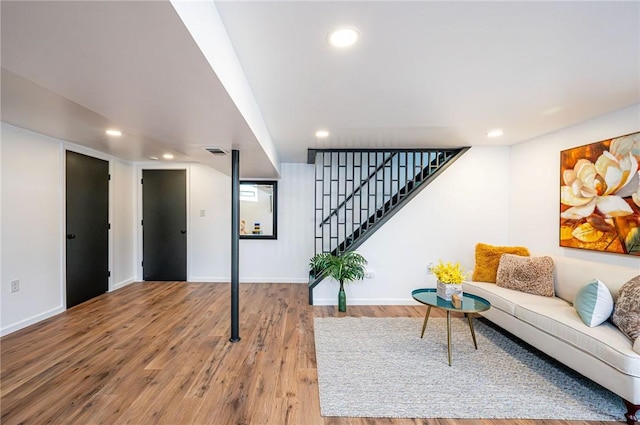 living room with stairway, visible vents, wood finished floors, and recessed lighting