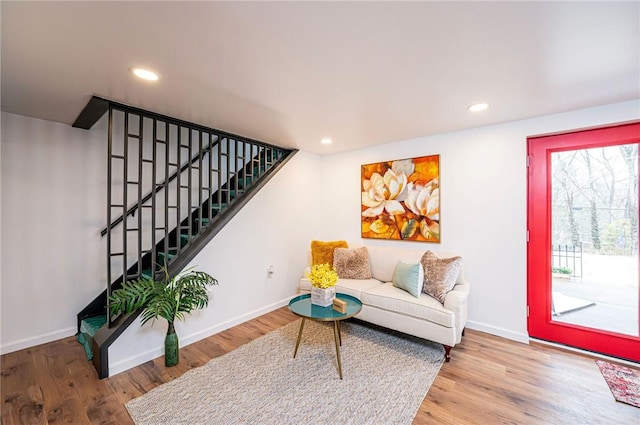 living area featuring stairway, recessed lighting, wood finished floors, and baseboards