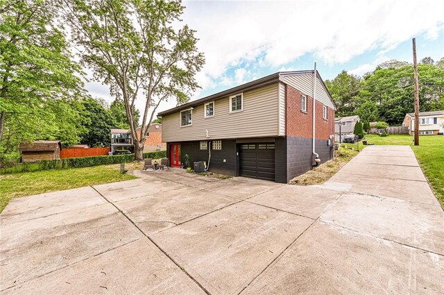 906 Tidal Terrace Dr, Shaler, PA 15101 - rear view of house featuring driveway, a yard, and an attached garage
