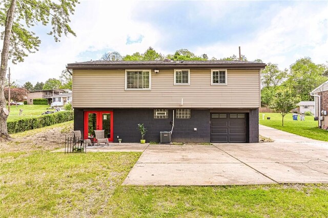 906 Tidal Terrace Dr, Shaler, PA 15101 - back of house featuring a lawn, an attached garage, concrete driveway, and central AC