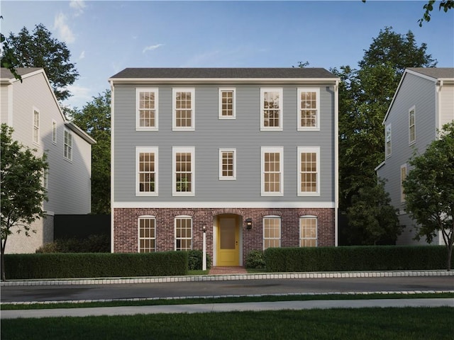 colonial-style house featuring brick siding