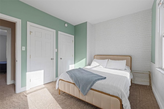 bedroom featuring carpet and baseboards