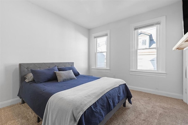 bedroom with carpet floors and baseboards