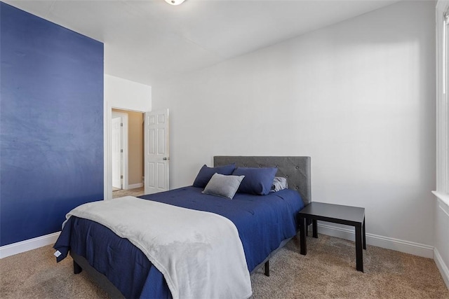 bedroom featuring carpet floors and baseboards