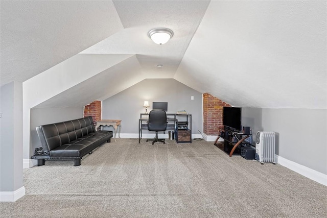 home office with radiator heating unit, carpet flooring, vaulted ceiling, a textured ceiling, and baseboards