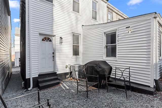 exterior space with central air condition unit, grilling area, and entry steps