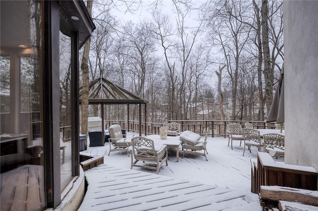 snow covered deck featuring an outdoor living space and a gazebo