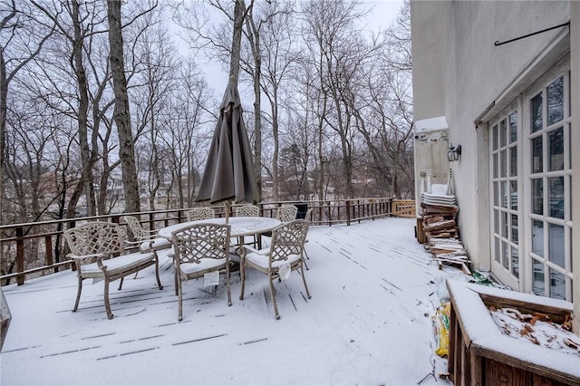 snow covered patio featuring outdoor dining area