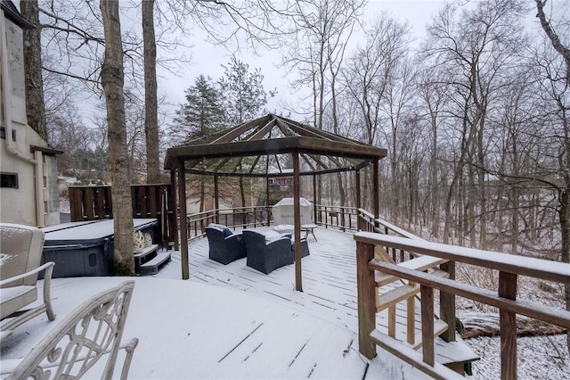 snow covered deck with a gazebo and a hot tub