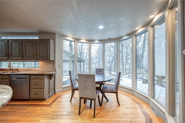 dining space featuring visible vents and light wood finished floors