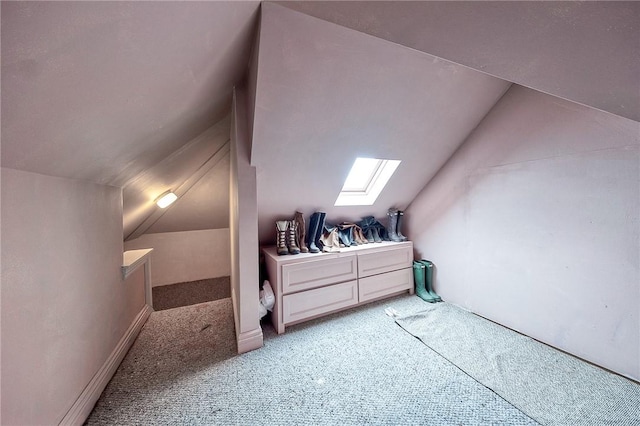 additional living space with light carpet and lofted ceiling with skylight