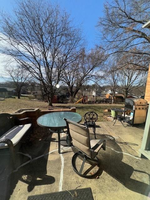 view of patio with a swimming pool and a grill