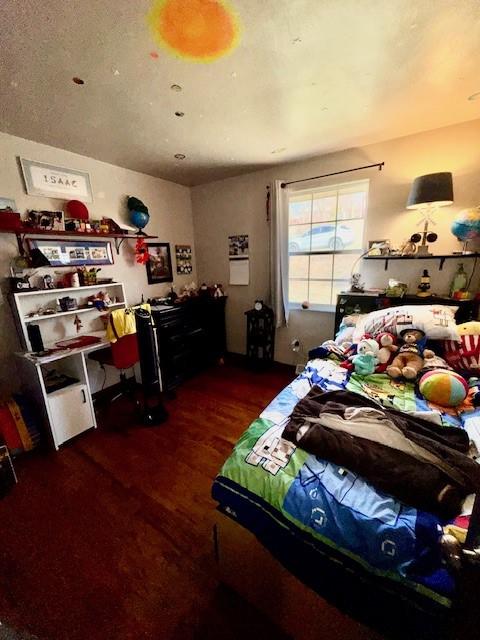 bedroom with wood finished floors