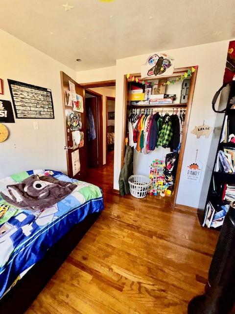 bedroom featuring a closet and wood finished floors