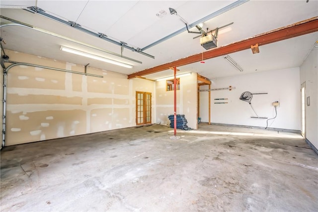 garage with a garage door opener and french doors