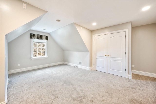 bonus room featuring lofted ceiling, carpet, and baseboards