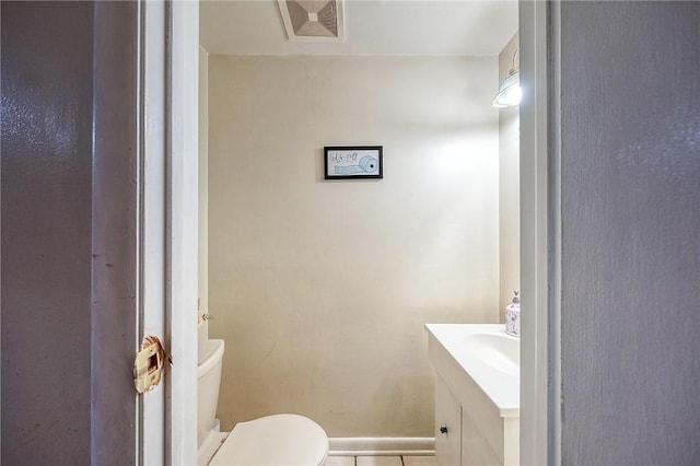 half bath with visible vents, vanity, and toilet