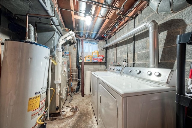 clothes washing area featuring laundry area, washer and dryer, and gas water heater