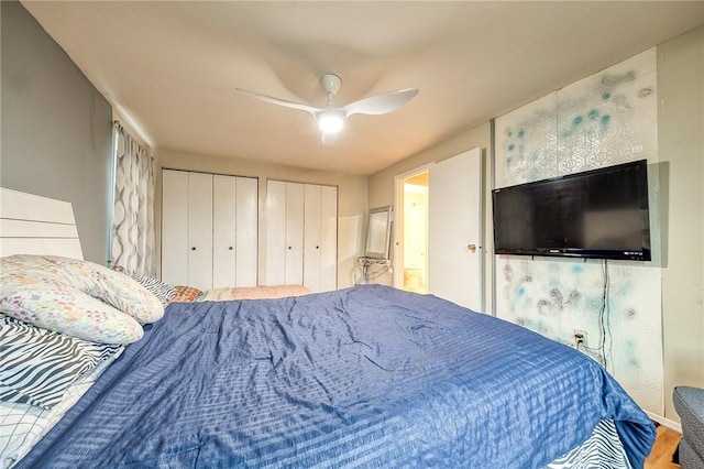 bedroom with multiple closets and ceiling fan