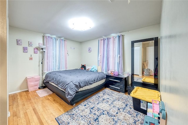 bedroom featuring baseboards and wood finished floors