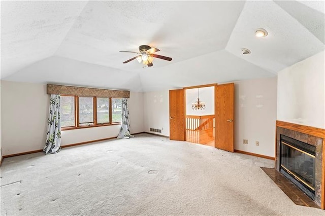 unfurnished living room featuring lofted ceiling, carpet floors, and a tiled fireplace