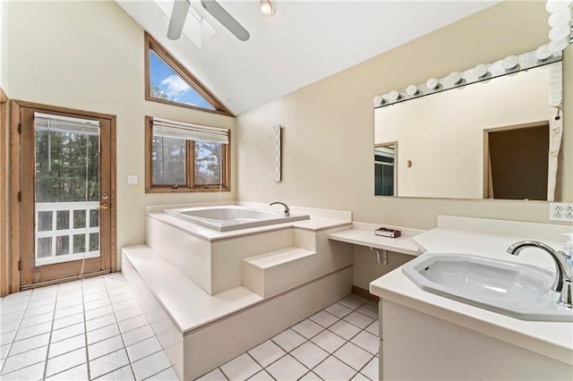 bathroom with ceiling fan, tile patterned floors, a garden tub, vaulted ceiling, and vanity