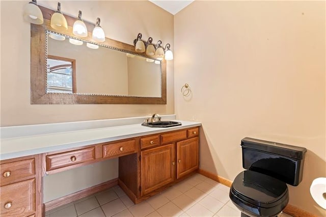 bathroom with tile patterned flooring, vanity, and baseboards