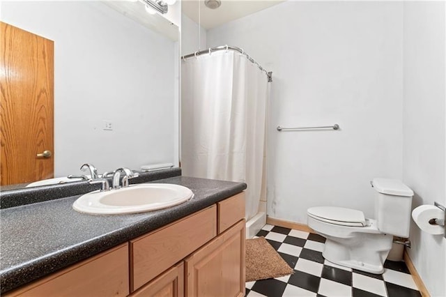 bathroom featuring baseboards, a shower with shower curtain, toilet, tile patterned floors, and vanity