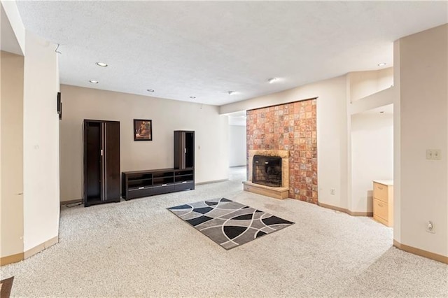 carpeted living room featuring a textured ceiling, recessed lighting, a brick fireplace, and baseboards