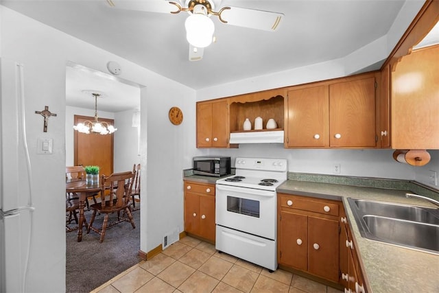 kitchen featuring brown cabinets, white appliances, a sink, and under cabinet range hood