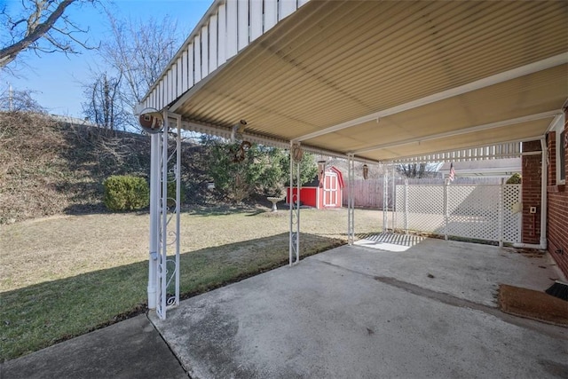 view of patio / terrace featuring fence, a storage unit, and an outdoor structure