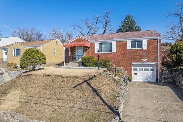 view of front facade featuring driveway, brick siding, and an attached garage