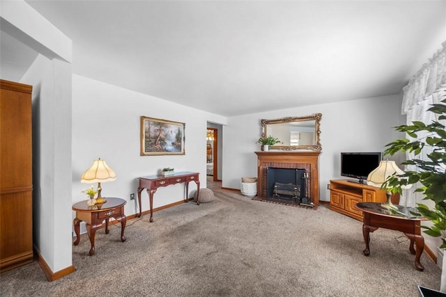 living room with carpet flooring, a fireplace with flush hearth, and baseboards