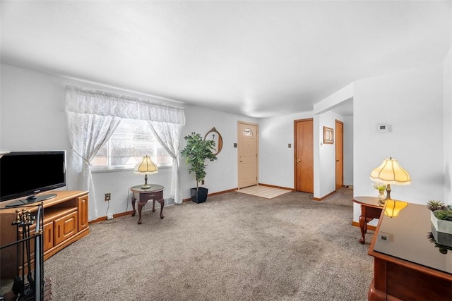 sitting room with baseboards and carpet flooring