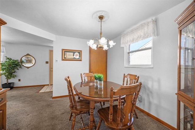 carpeted dining area with baseboards and an inviting chandelier