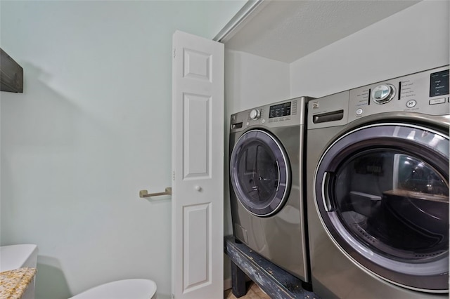 laundry room with laundry area and washing machine and clothes dryer