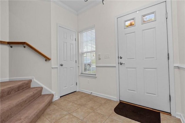 entrance foyer with baseboards, stairway, crown molding, and light tile patterned flooring