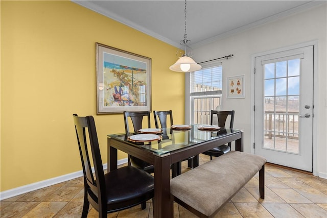 dining area featuring ornamental molding and baseboards