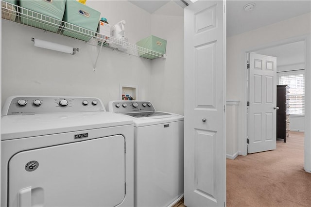 laundry area with laundry area, light carpet, baseboards, and washing machine and clothes dryer