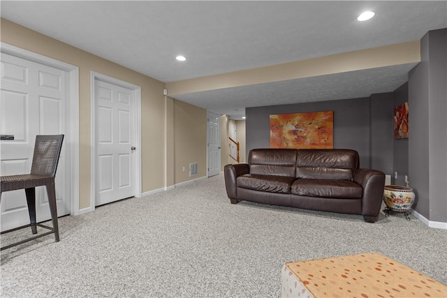 carpeted living room featuring stairway, visible vents, baseboards, and recessed lighting